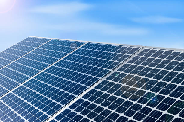istock Solar Panel Plates with Blue sky and sunlight Background. Clean energy concept backdrop with 3d rendered solar panels 1411013384