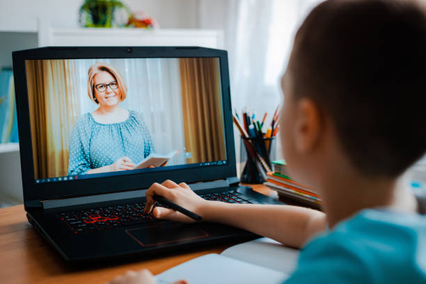 istock Distance learning online education. A schoolboy boy studies at home and does school homework. A home distance learning 1411013415