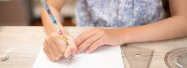 istock Hands of a child studying at home 1411013931