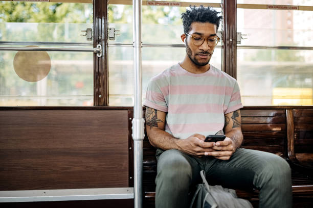 istock Casually clothed man texting while riding in the bus 1411014423