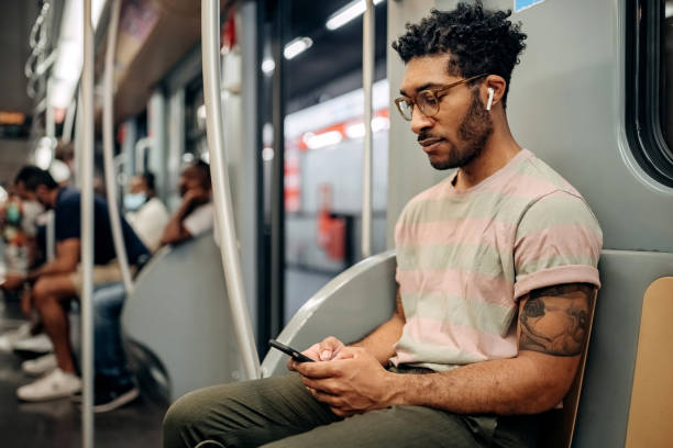 istock Casually clothed man texting while riding in the metro 1411015074