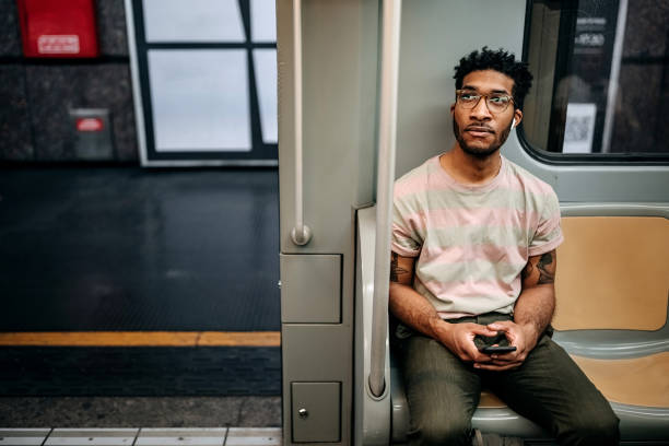 istock Casually clothed man texting while riding in the metro 1411015083