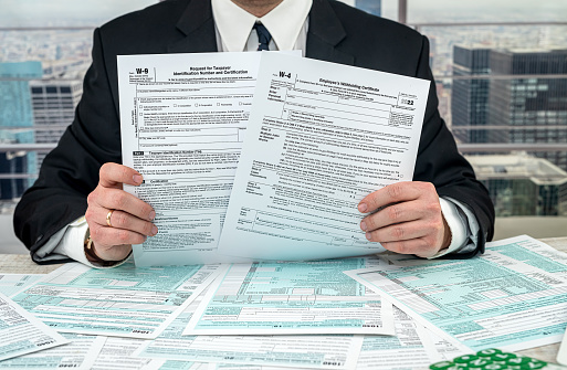 man wear suit filling tax form, business concept
