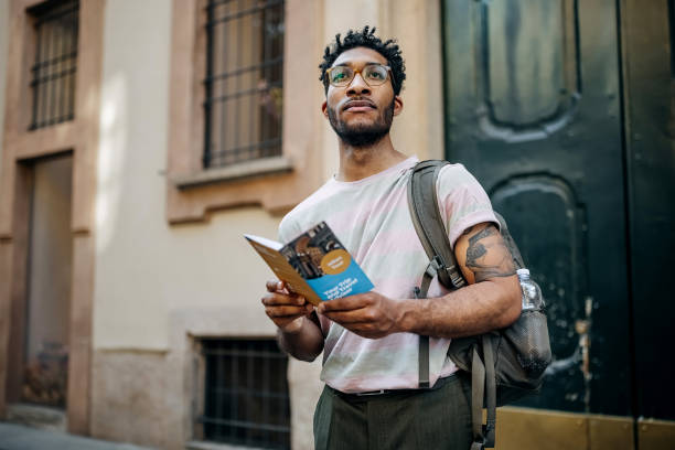 Tourist exploring city while golding travel pamphlet