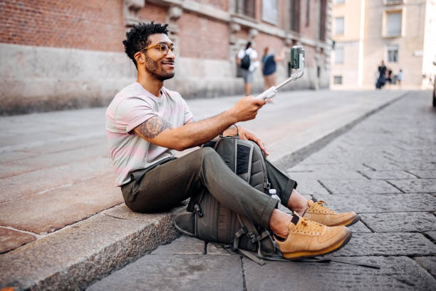 istock Hipster man travel vlogging from the city 1411015520