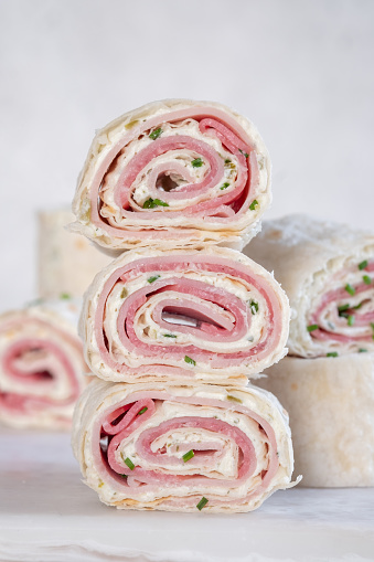 Ham and cream cheese rolled up in a flour tortilla