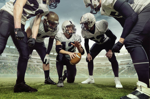 Teammates. Team of male american football players before sport match at stadium over cloudy sky background with flashlights. Collage Teammates. Team of male american football players before sport match at stadium over cloudy sky background with flashlights. Concept of sport, challenges, goals, strength. team event stock pictures, royalty-free photos & images