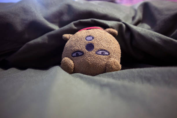 istock little doll on bed covered with bed sheet 1411017397