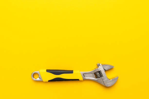 istock adjustable wrench with yellow handle on the yellow background with copy space 1411017655