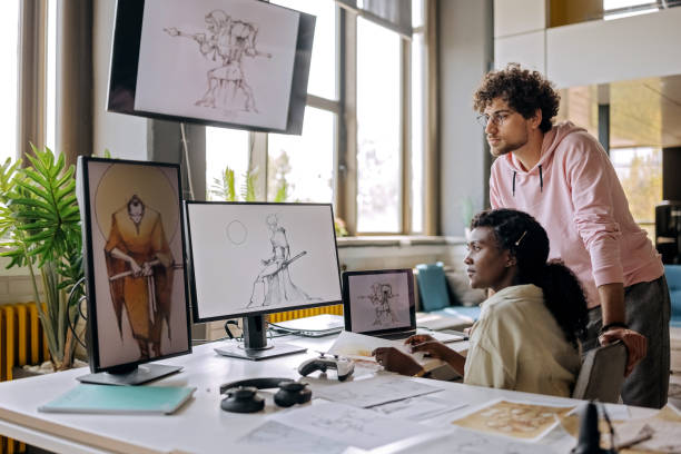 istock Two young gaming designers going over character sketches for their new game 1411018990
