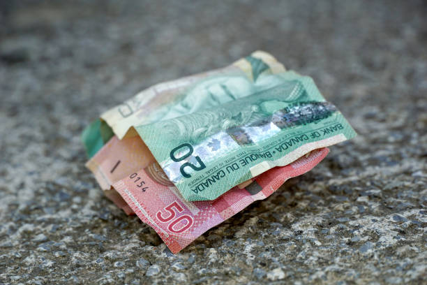 istock canadian dollars banknote on concrete background. 1411019608