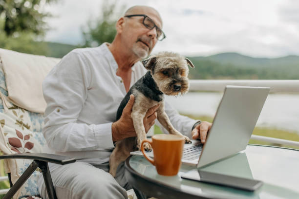 istock Senior man and dog on a video call 1411019856