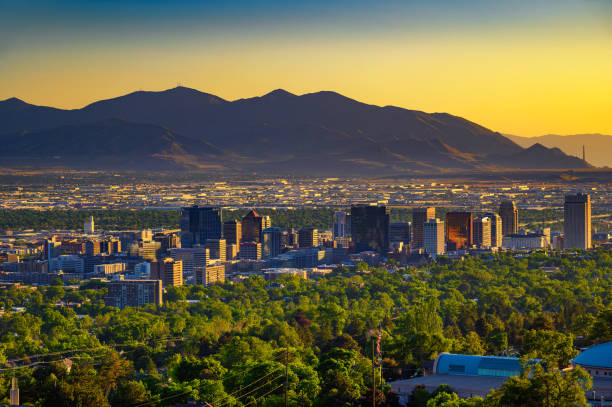 Salt Lake City skyline at sunset with Wasatch Mountains in the background, Utah stock photo