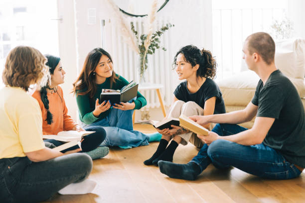 Happy people discussing a new book stock photo