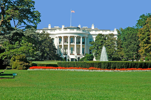 The Front Lawn of the White House with American Flag in Washington, DC.