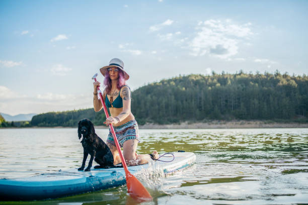 istock Woman taking her dog on a paddle board ride. 1411022113