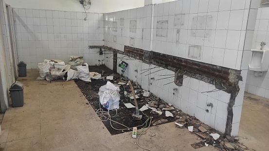 Interior background of a restroom is under renovation with some material inside the room
