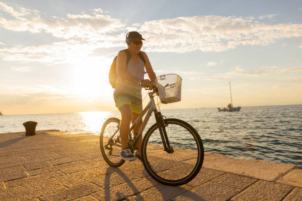 istock Riding a bike on a beautiful sunset 1411024899