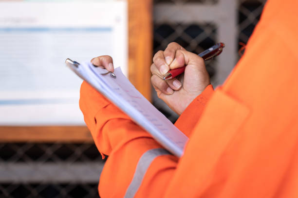 istock Writing on paper during  safety audit and inspection working action. 1411026145