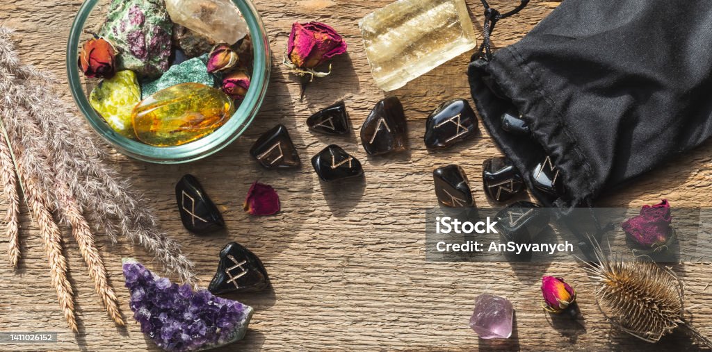 Natural minerals and rune stones set up on wood Natural minerals and rune stones set up on wood. Magical ritual process, future telling concept Runes Stock Photo