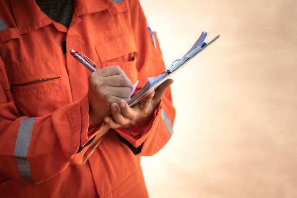 istock Writing on paper during  safety audit and inspection working action. 1411026254