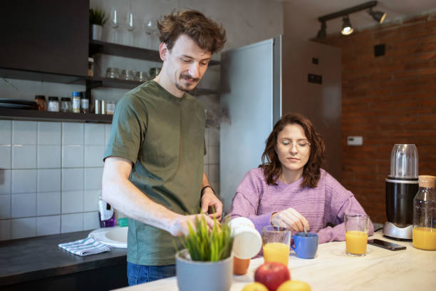 istock Couple making coffee at home 1411026746