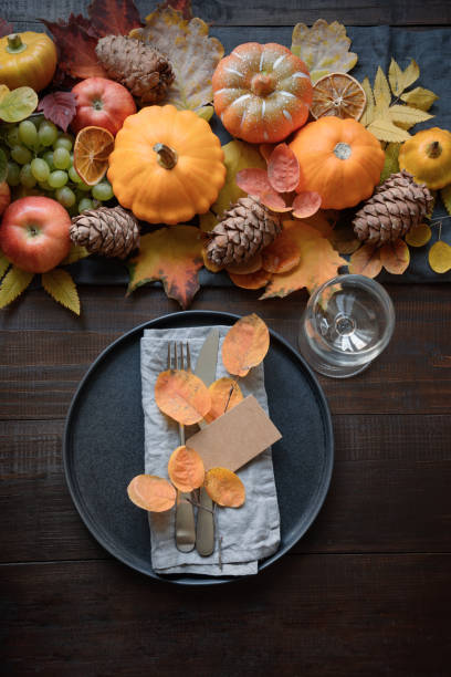 istock Autumn place setting with leaves and pumpkins 1411027559
