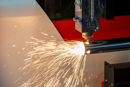 The fiber laser cutting machine cutting  machine cut the metal tube. The hi-technology sheet metal manufacturing process by laser cutting machine.
