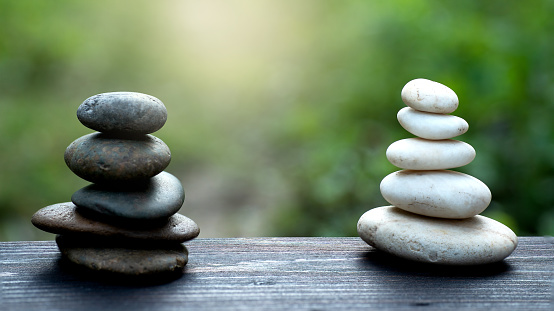 Black and White zen stones Balance Meditation with blurred green nature background, religion of Zen peaceful symbol meditation