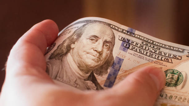istock Focused fragment of an hundred dollar bill for abstract background 1411029621