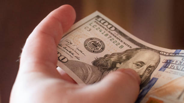 istock Focused fragment of an hundred dollar bill for abstract background 1411029633