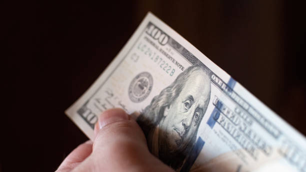 istock Focused fragment of an hundred dollar bill for abstract background 1411029707