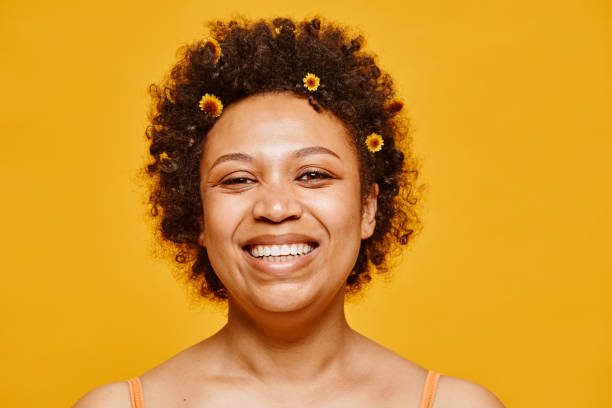 istock Smiling Black Woman with Flowers 1411029793