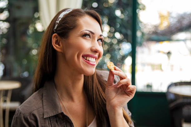 istock Smiling woman enjoying cookie 1411029851