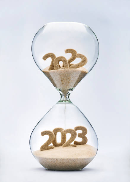 Passing into New Year 2023 New Year 2023 concept with hourglass falling sand taking the shape of a 2023 the end stock pictures, royalty-free photos & images