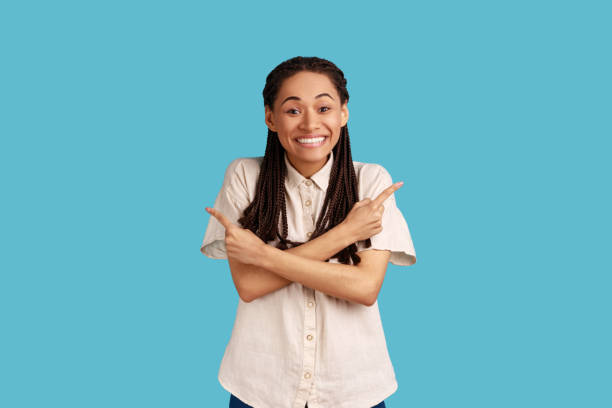 istock Extremely happy woman crosses arms and points at different sides showing two items or variants. 1411032733