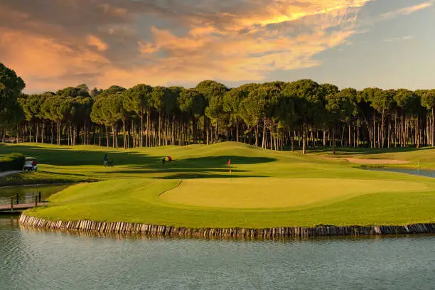 Beautiful sky over the golf course which is located behind the lake with fountains.