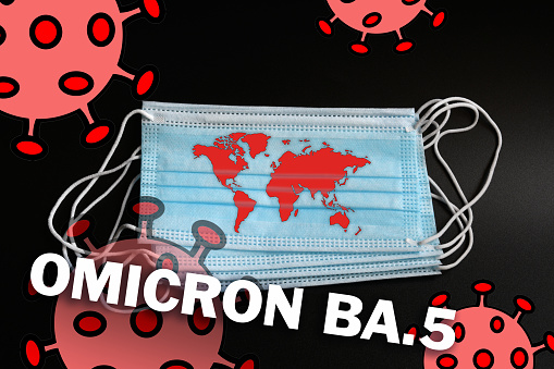 earth map on the protection mask along with coronavirus and Omicron BA.5 text. Dramatic increase in infections due to the new variant Omicron BA.5 of the SARS-CoV-2 virus.