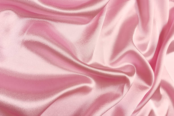 istock Pink crepe satin crumpled or wavy fabric texture background. Abstract linen cloth soft waves. Silk fabric. Smooth elegant luxury cloth texture. Concept for banner or advertisement 1411035171