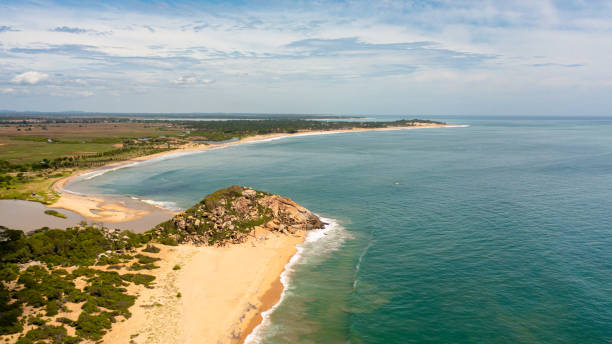 istock Top view of a beautiful sandy beach and ocean with waves. 1411035347