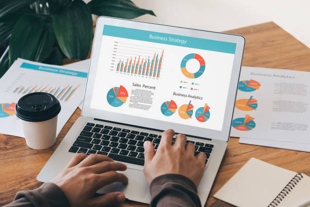istock accounting concept. businessman working using a laptop with analyzing finance sales data and economic growth graph chart. at the coffee shop. 1411036519