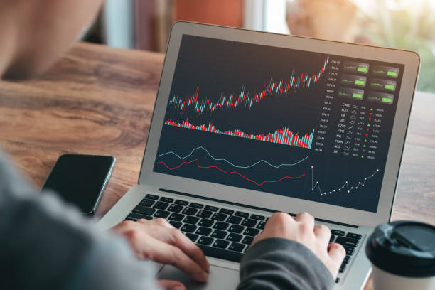 istock Businessmen work with stock market investments using laptops to analyze trading data. desktop computer with stock exchange graph on screen. Financial stock market. Analyzing data in office background. 1411037244