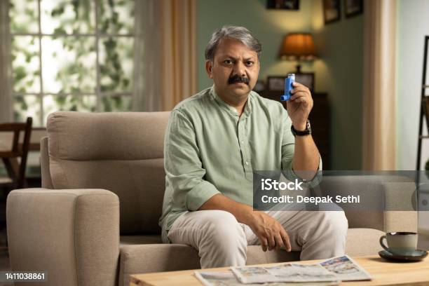 Mature Man Showing Asthma Pump Stock Photo Stock Photo - Download Image Now - Asthma Inhaler, Holding, One Person