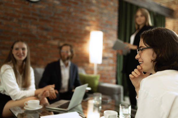 istock Young people, students having meeting with teacher, coach on modern office 1411040736