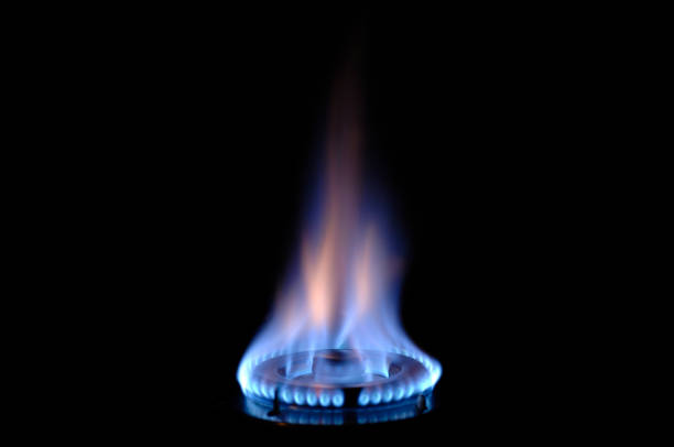 gas flame burns on a stove stock photo