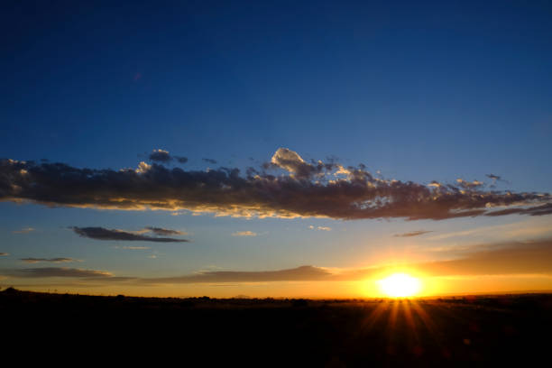 istock Sun Setting Sunset or Rise Sunrise with Sunstar Rays of Light with Clouds in Sky 1411042997