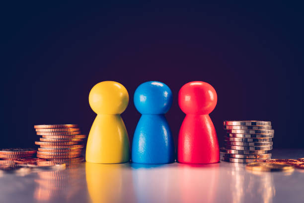 Closeup colorful wooden block people shape with stack coins