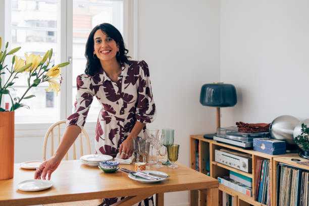 istock A Happy Elegant Woman Looking At Camera While Preparing Table For Lunch Before Guests Come 1411043434