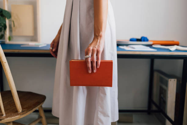 istock An Unrecognizable Teacher Holding A Book While Standing In The Classroom 1411043508