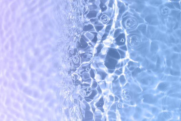 istock Transparent clear calm water surface texture with waves, splashes and bubbles. Trendy abstract nature background. White and blue water waves in sunlight. Organic drop shadow caustic effect mock up. 1411044423